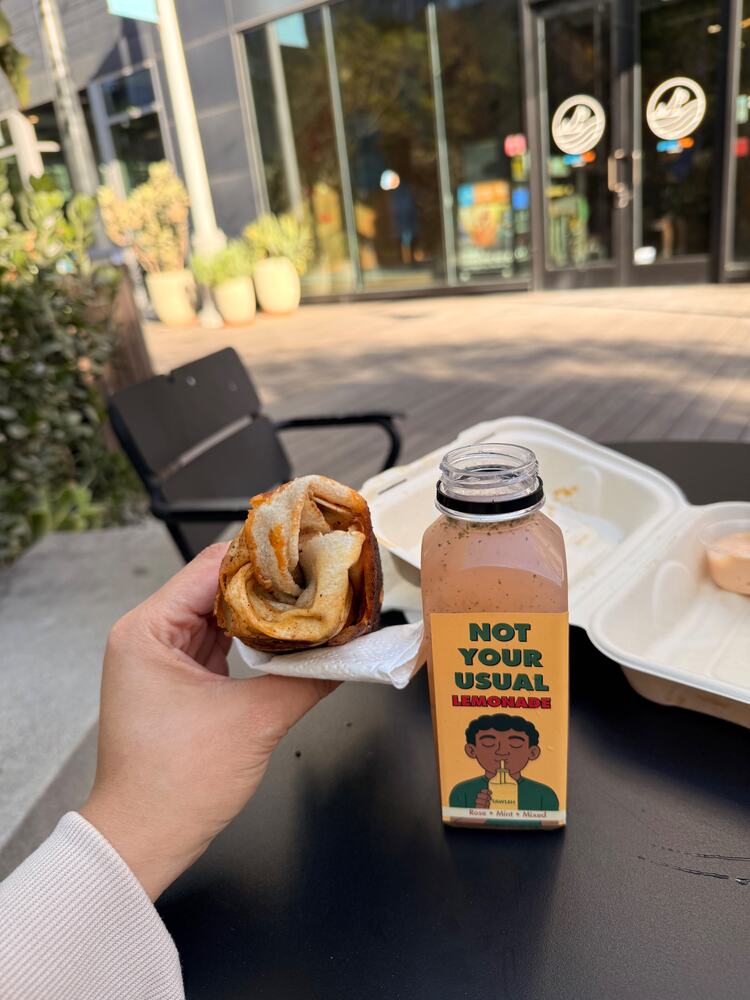 A wrap and a lemonade at an outdoor table